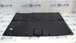 The trunk floor of a 12-14 Toyota Prius V is dark gray, scratches, and needs cleaning.