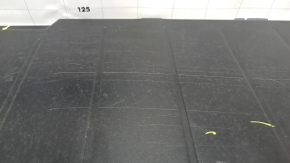 The trunk floor of a 12-14 Toyota Prius V is dark gray, scratches, and needs cleaning.