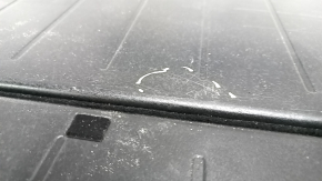 The trunk floor of a 12-14 Toyota Prius V is dark gray, scratches, and needs cleaning.