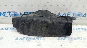 The lower control arm cover under the rear left spring of the Audi Q5 80A 18-24 is dented, worn, and has tears.