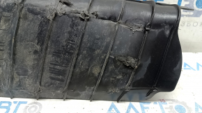 The lower control arm cover under the rear left spring of the Audi Q5 80A 18-24 is dented, worn, and has tears.