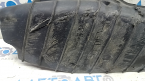 The lower control arm cover under the rear left spring of the Audi Q5 80A 18-24 is dented, worn, and has tears.