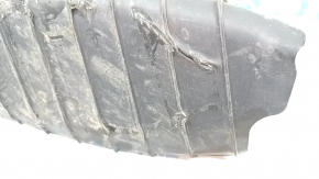 The lower control arm cover under the rear right spring of the Audi Q5 80A 18-24 is dented, worn, and has tears.