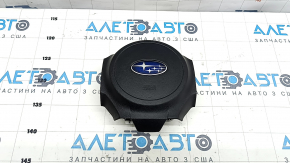 The driver's side airbag in the steering wheel of a Subaru Forester 17-18 SJ is black, scratched, and has a rusty piston.