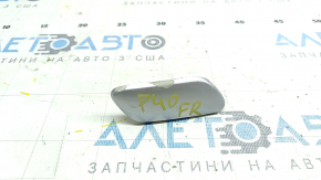 The paint is peeling off the right headlight washer cap on a Toyota Prius V 12-14.