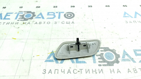 The paint is peeling off the right headlight washer cap on a Toyota Prius V 12-14.