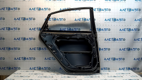 The rear left door of a Hyundai Sonata 15-19 is bare, with a small dent.