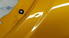 Front right fender of a 2015 Ford Bronco Sport, orange SB, bumps, dent