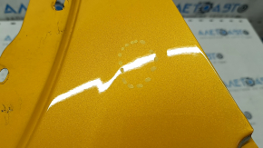 Front right fender of a 2015 Ford Bronco Sport, orange SB, bumps, dent