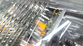 Left headlight of a 1992 Toyota Prius V, scratches, and sand.