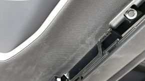 Black rear left door panel for a 2021 Ford Bronco Sport with a handle, gray molding, black leather armrest, plastic insert, scratches, worn, whitened plastic