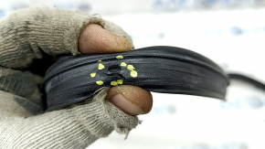 The front right door seal of a 2021 Ford Bronco Sport has a torn fastener.