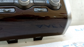 Climate control and audio control for a 13-16 Nissan Pathfinder with navigation, wood grain, scratches, and a worn trim panel