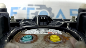 The steering wheel airbag for the driver's side of the Ford Bronco Sport 2021-2025 is black and has a rusty squib.