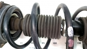 The front right shock absorber assembly for a Nissan Leaf 11-17 has a torn boot.