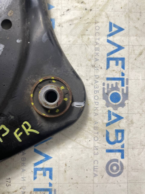 The lower front right control arm of a Nissan Leaf 11-17 has a torn silent block.
