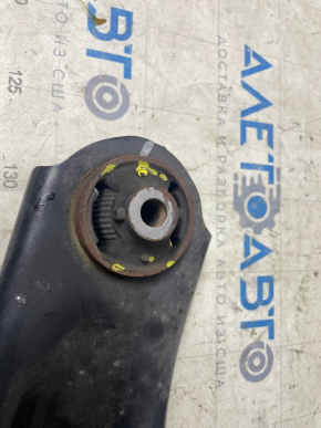 The lower front right control arm of a Nissan Leaf 11-17 has a torn silent block.