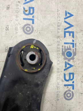 The lower front right control arm of a Nissan Leaf 11-17 has a torn silent block.