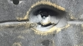 The right underbody protection of a 2021 Ford Bronco Sport is dented and torn.