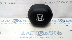 The Honda Accord 23-24 driver's steering wheel airbag is black and has a rusty squib.