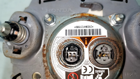 The Honda Accord 23-24 driver's steering wheel airbag is black and has a rusty squib.