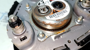 The Honda Accord 23-24 driver's steering wheel airbag is black and has a rusty squib.