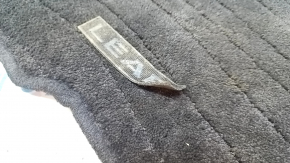 Front left Nissan Leaf 13-17 floor mat, black, torn emblem