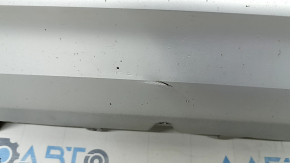 The front bumper lip of the Volvo XC90 16-19 is dented and scratched.