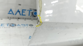 The front right door of a BMW X5 G05 19-24 white 300 is bare, has a dent, and chips.