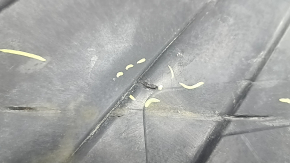 The rear left underbody protection of the BMW X5 G05 19-24 is dented and torn.