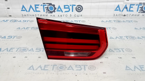 The left inner taillight of a BMW 3 F30 16-18 is light, the guide is broken, and there is a scratch.