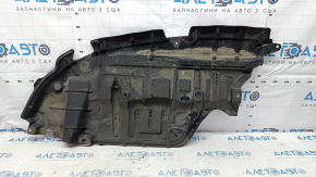 The left engine guard of a Toyota Avalon 13-15 is dented and torn.