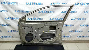 The front right door of a Toyota Avalon 13-18 beige 5B2 is bare and dented.