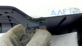 The trunk door trim of a 19-2019 Toyota Highlander is black, with plugs, scratches, and broken fasteners.