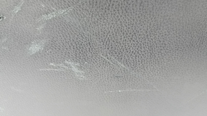 The trunk door trim of a 19-2019 Toyota Highlander is black, with plugs, scratches, and broken fasteners.