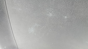 The trunk door trim of a 19-2019 Toyota Highlander is black, with plugs, scratches, and broken fasteners.