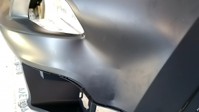 The front bumper is bare, the upper part of the Jeep Cherokee KL 14-14 without parking sensors, under the towing hook plug, dented