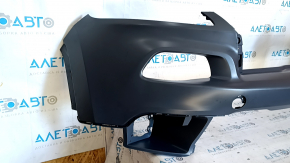 The front bumper is bare, the upper part of the Jeep Cherokee KL 14-14 without parking sensors, under the towing hook plug, dented