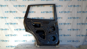 The rear left door of a Nissan Rogue 14-20 is bare and dented.