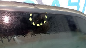 Rear left Nissan Pathfinder 13-20 window with scratches on the glass.
