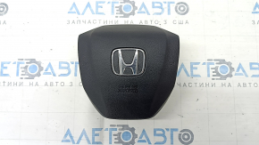 The Honda CRV 20-22 driver's steering wheel airbag is black and has a rusty squib.