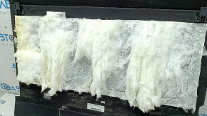 The trunk floor of a Honda CRV 20-22 hybrid is black and needs dry cleaning. The insulation is torn.