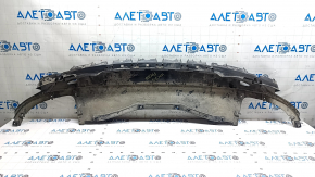 The front bumper center guard for Volkswagen ID.4 23-25 is worn and cracked.