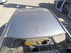 The metal roof of a 19-22 Honda Insight, without a sunroof, is on the body and is dented.