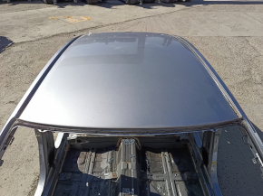The metal roof of a 19-22 Honda Insight, without a sunroof, is on the body and is dented.
