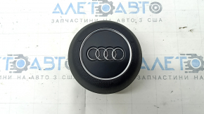 The Audi A4 B9 17-25 steering wheel airbag, black, scratched.