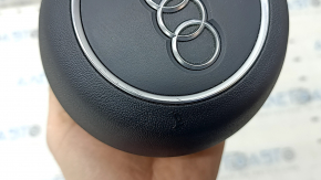 The Audi A4 B9 17-25 steering wheel airbag, black, scratched.