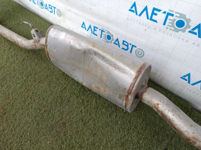 The exhaust pipe with the rear barrel of a Honda CRV 20-22 hybrid is rusty and dented.