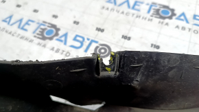 The right front bumper guard for a Volkswagen ID.4 21-22 is worn and the fasteners are torn.