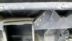 The bare rear bumper, upper part of the Audi Q3 8U 16-18, under 2 parking sensors, is dented, scratched, and cracked.